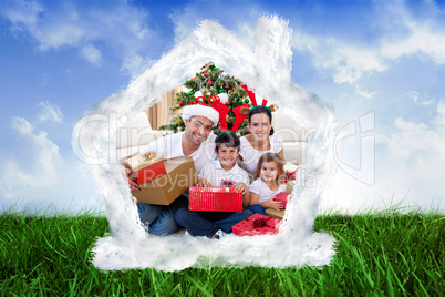 Composite image of happy family celebrating christmas at home