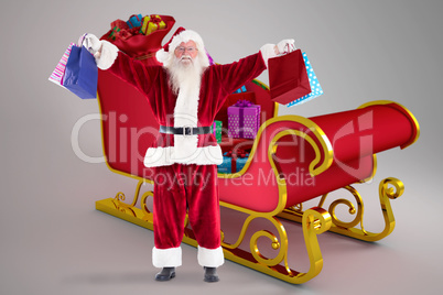 Composite image of santa holds some bags for chistmas