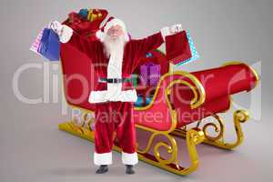 Composite image of santa holds some bags for chistmas