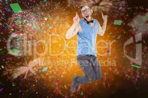 Composite image of geeky hipster jumping and smiling