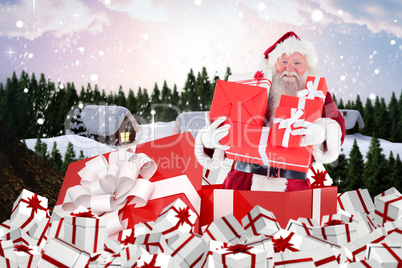 Composite image of santa standing in large gift