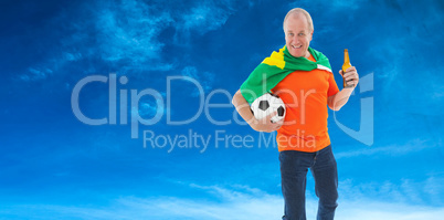 Composite image of mature man in orange tshirt holding football
