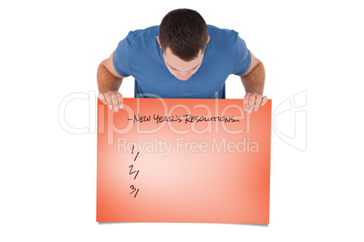 Composite image of portrait of a man looking at a blank panel