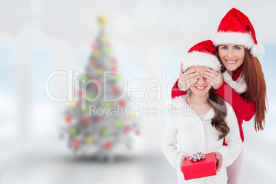 Composite image of mother and daughter with gift