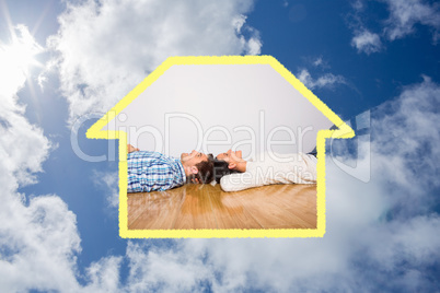 Composite image of young couple lying on floor smiling