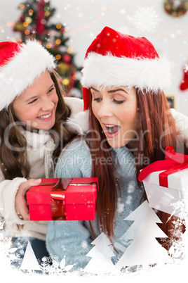 Composite image of festive mother and daughter exchanging gifts