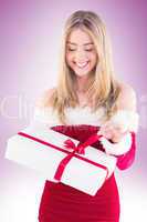 Pretty santa girl opening gift