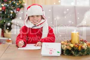 Composite image of festive little boy smiling at camera