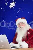 Composite image of santa surfs on the internet