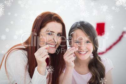 Composite image of festive mother and daughter baking together