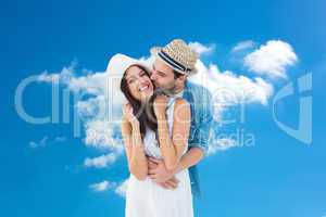 Composite image of happy hipster couple hugging and smiling