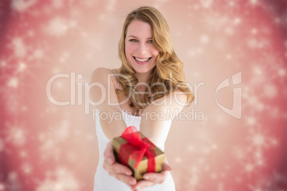 Composite image of smiling blonde offering a small gift