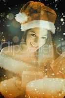 Composite image of pretty brunette in santa outfit opening gift