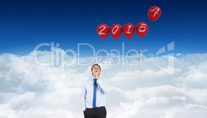 Composite image of thinking businessman touching his chin