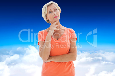 Composite image of thinking older woman with arms crossed