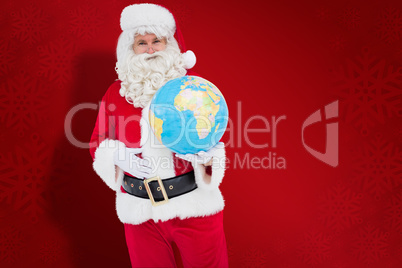 Composite image of happy santa claus holding a globe