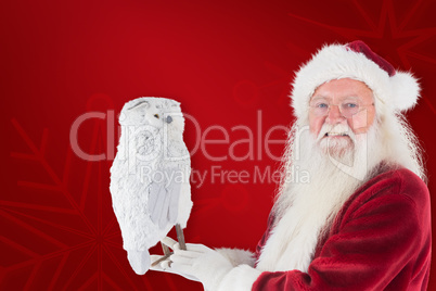 Composite image of father christmas holds an owl