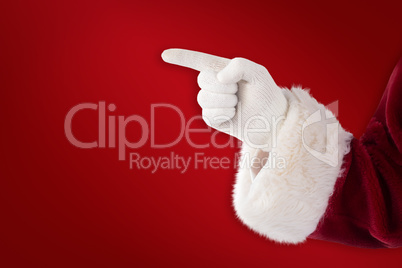 Composite image of santa claus points at something