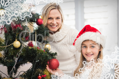 Composite image of festive mother and daughter decorating christ