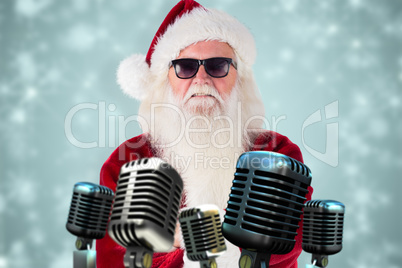 Composite image of santa claus wears black sunglasses