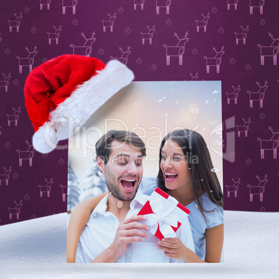 Composite image of woman surprising boyfriend with gift