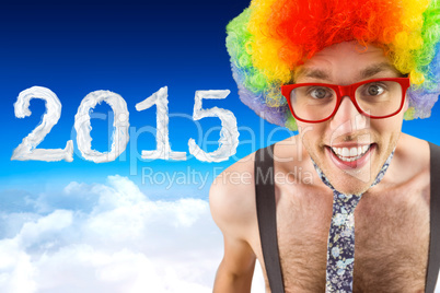 Composite image of geeky hipster in afro rainbow wig