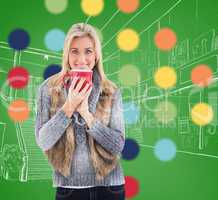 Composite image of woman in winter clothes holding a mug