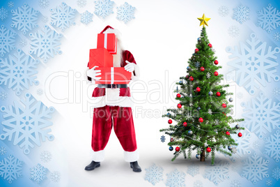 Composite image of santa covers his face with presents