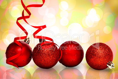 Composite image of four red christmas ball decorations