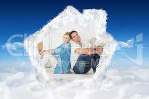 Composite image of smiling couple with boxes in a new house