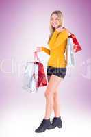 Stylish blonde smiling with shopping bags