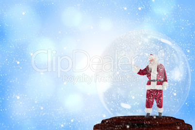 Composite image of santa presenting in a snow globe