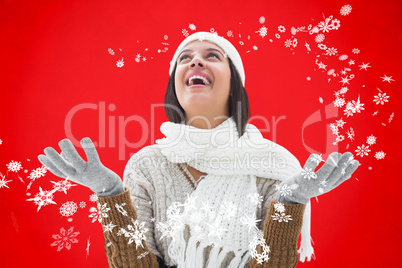 Composite image of brunette in warm clothing