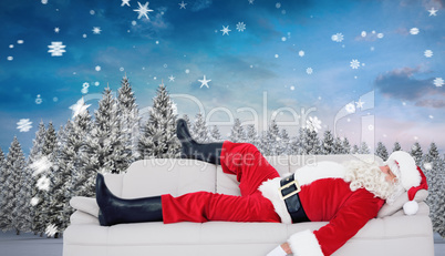 Composite image of santa claus sleeping on the couch