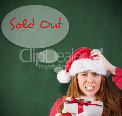 Composite image of festive stressed redhead holding gifts