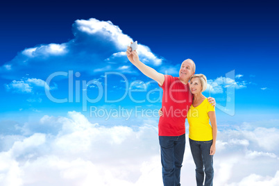 Composite image of happy mature couple taking a selfie together