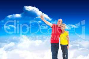 Composite image of happy mature couple taking a selfie together