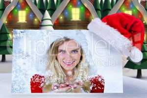 Composite image of pretty girl in santa outfit with hands out