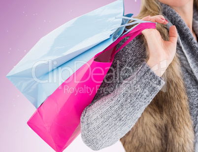 Blonde in winter clothes holding shopping bags