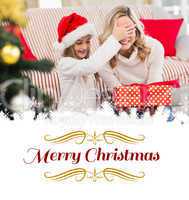 Composite image of festive mother and daughter with gift