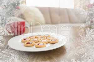Composite image of cookies and mug on coffee table at christmas