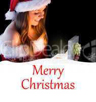 Composite image of pretty brunette in santa outfit opening gift