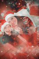 Composite image of festive mother and daughter using tablet pc