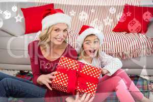 Composite image of festive mother and daughter smiling at camera