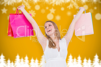 Composite image of blonde woman raising shopping bags