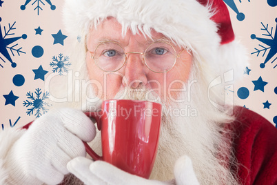 Composite image of santa drinks from a red cup