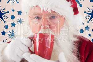 Composite image of santa drinks from a red cup
