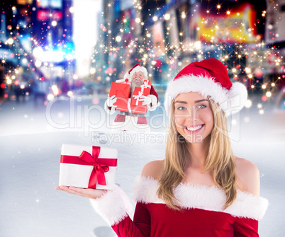 Composite image of pretty santa girl holding gift