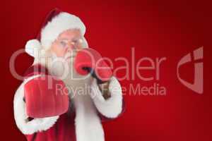Composite image of santa claus punches with his right