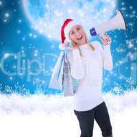 Composite image of festive blonde holding gift bags and megaphon